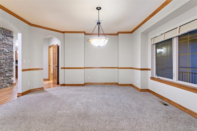 carpeted spare room with ornamental molding