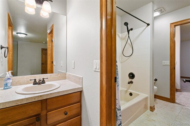 full bathroom featuring tile flooring, vanity with extensive cabinet space, shower / tub combo with curtain, and toilet