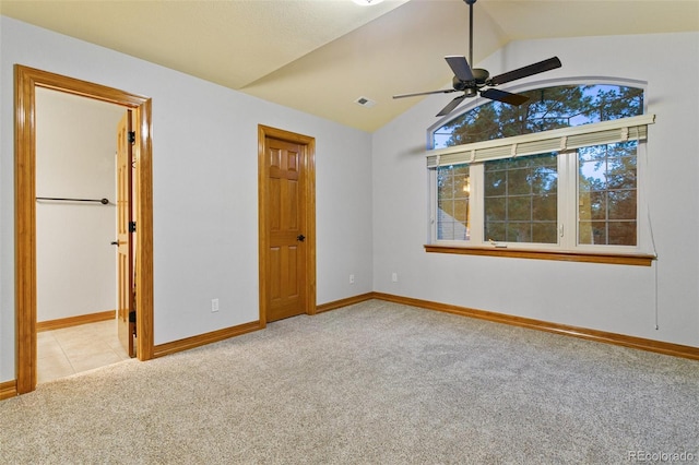 unfurnished bedroom with carpet flooring, ceiling fan, and lofted ceiling