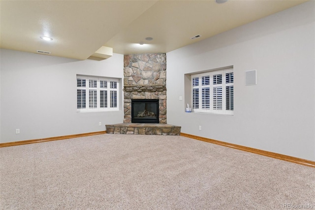 unfurnished living room featuring a fireplace and carpet floors