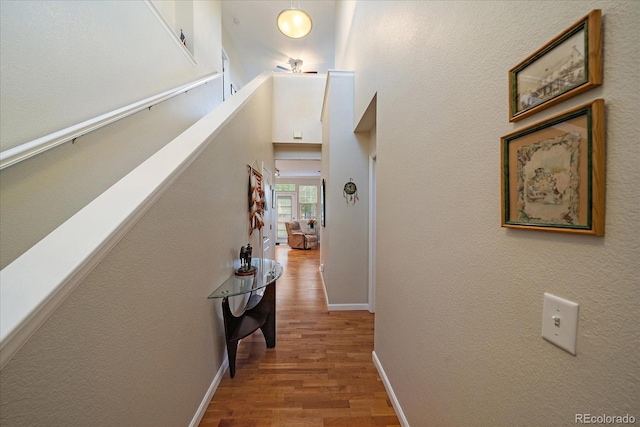 12856 King St, Broomfield, CO 80020 - hallway with wood finished floors and an upstairs landing