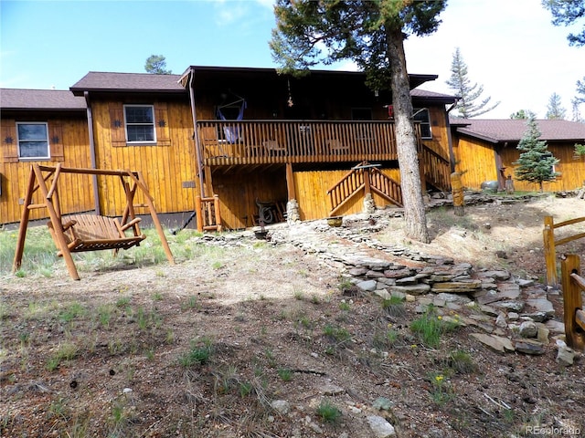 back of property featuring a wooden deck