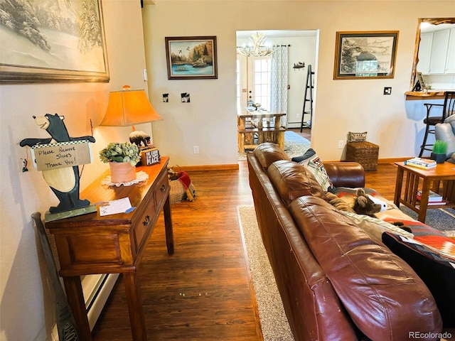 living room with a notable chandelier and dark wood-type flooring