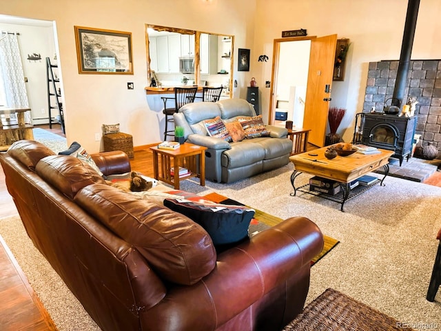 living room with wood-type flooring and a wood stove