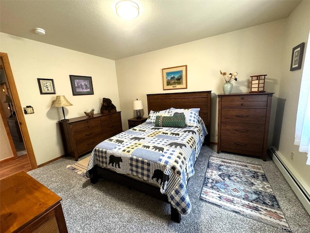 carpeted bedroom with a baseboard heating unit