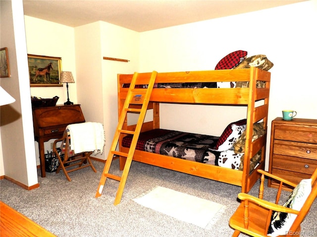 bedroom featuring baseboards and carpet flooring