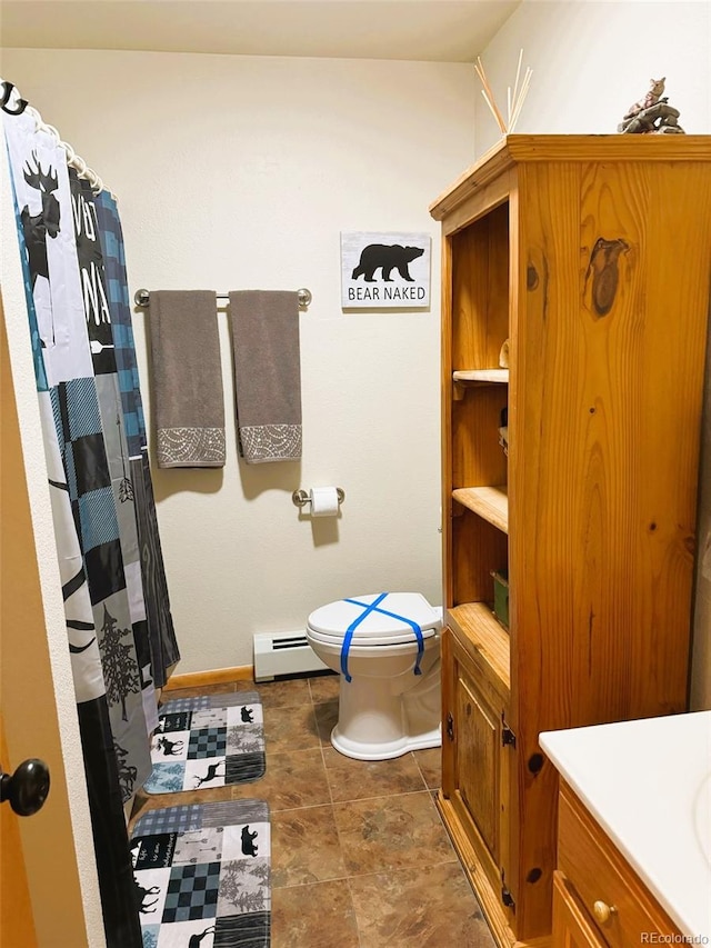 bathroom with tile patterned floors, toilet, vanity, and baseboard heating