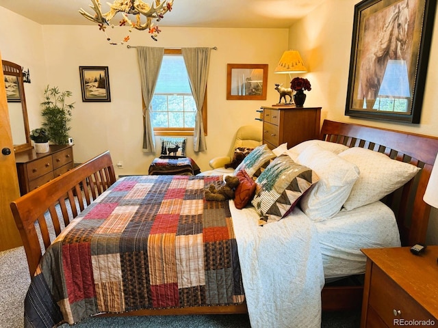 bedroom featuring carpet flooring and a chandelier