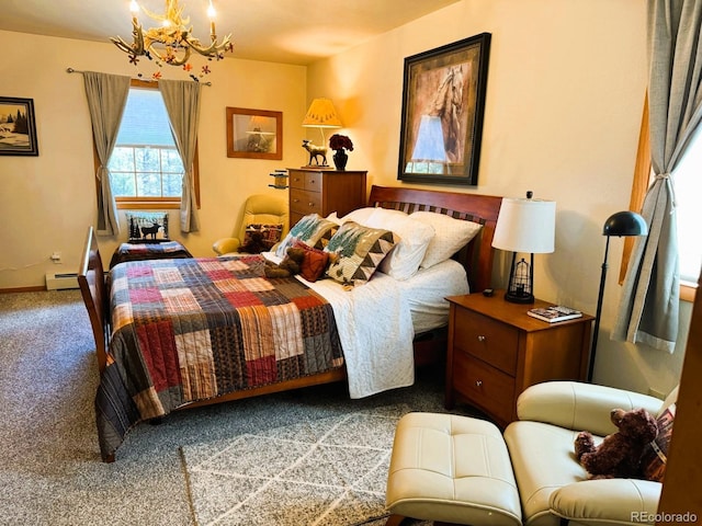 bedroom featuring carpet, a baseboard heating unit, and a notable chandelier