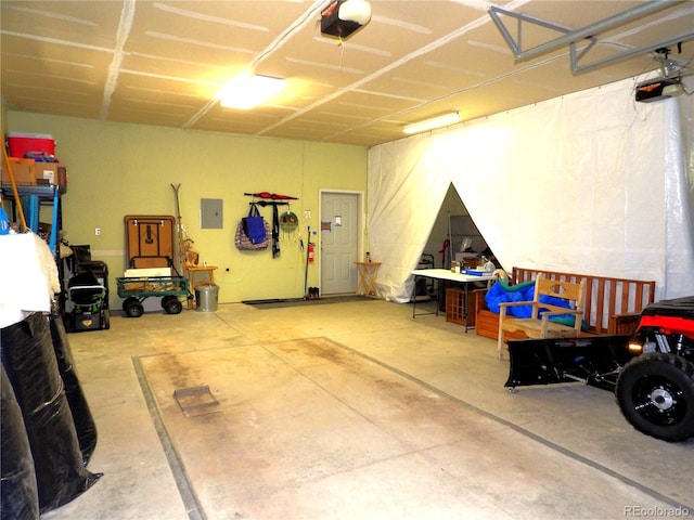 garage with electric panel and a garage door opener