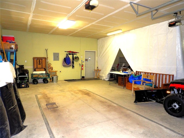 garage featuring electric panel and a garage door opener