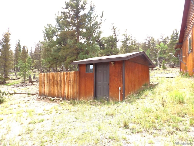 view of shed with fence