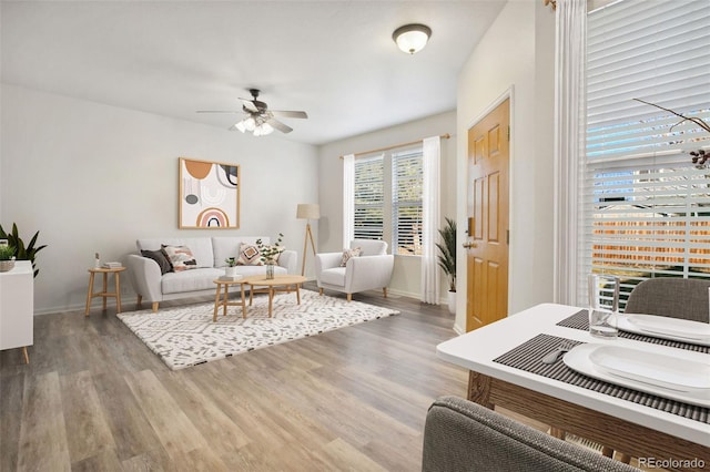 living room with hardwood / wood-style flooring and ceiling fan