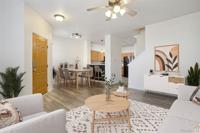 living room with hardwood / wood-style floors and ceiling fan