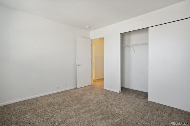 unfurnished bedroom featuring carpet and a closet