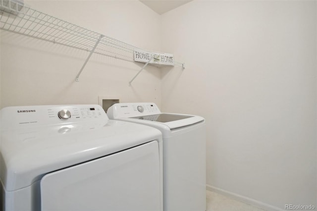 laundry area featuring laundry area, washer and clothes dryer, and baseboards