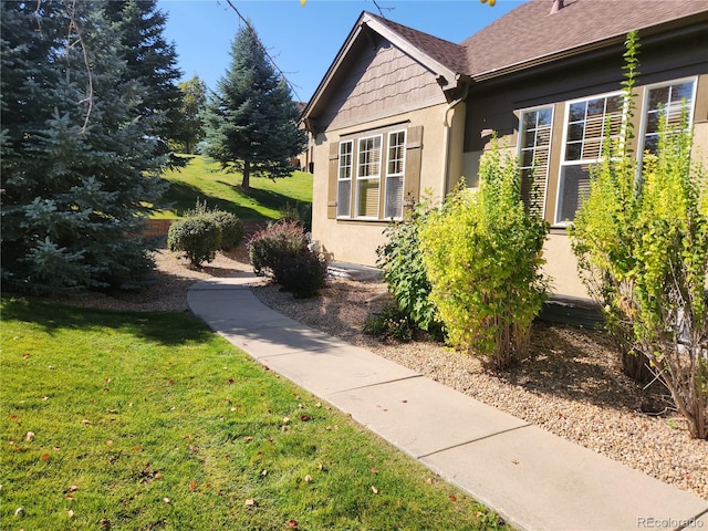 view of side of home with a lawn