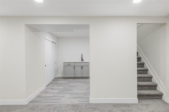 interior space featuring sink and light colored carpet