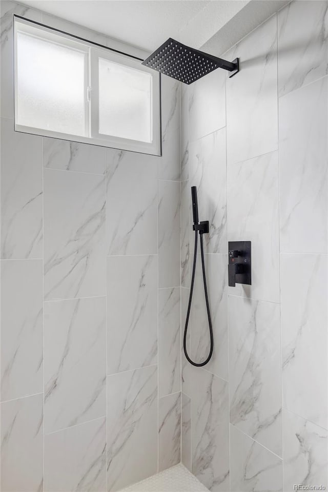 bathroom with a tile shower