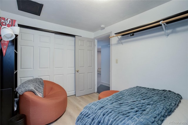 bedroom with a closet and light hardwood / wood-style flooring