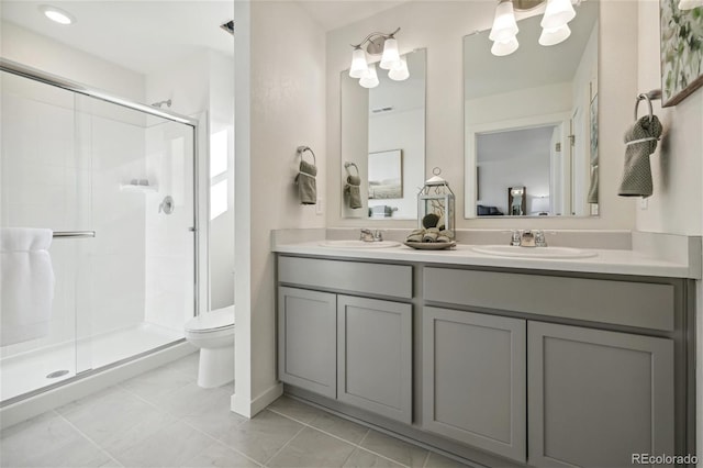 full bath with a sink, toilet, double vanity, and a stall shower