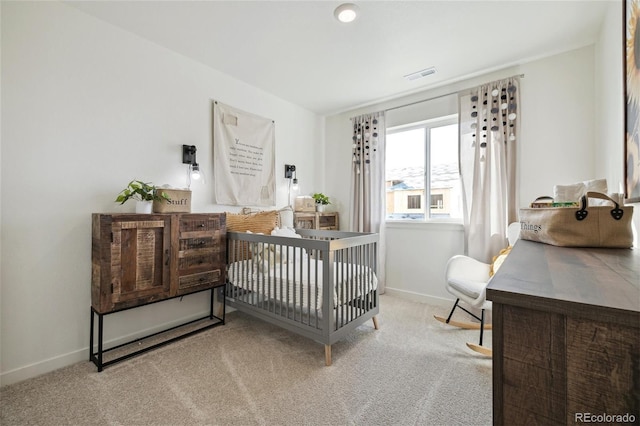 carpeted bedroom featuring visible vents and baseboards