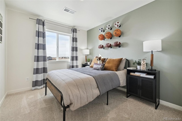 bedroom featuring visible vents, baseboards, and carpet