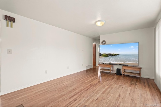 6627 Eaton St, Arvada, CO 80003 - unfurnished living room with wood finished floors, baseboards, and a water view