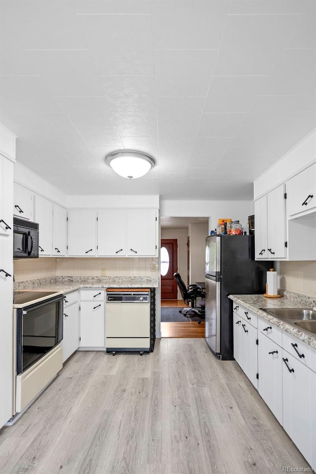 6627 Eaton St, Arvada, CO 80003 - kitchen with white appliances, a sink, light countertops, white cabinetry, and light wood-style flooring