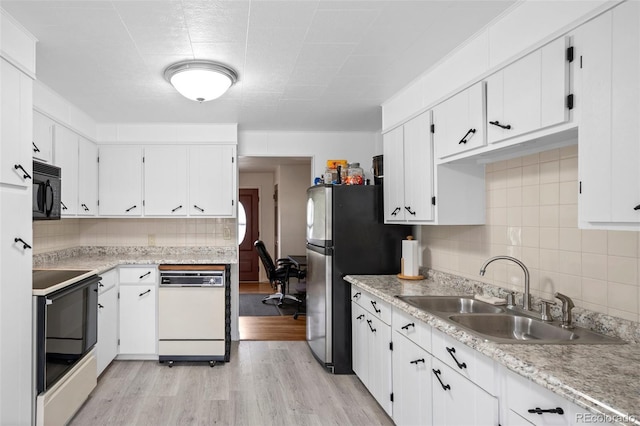 6627 Eaton St, Arvada, CO 80003 - kitchen featuring dishwasher, a sink, freestanding refrigerator, black microwave, and range with electric stovetop
