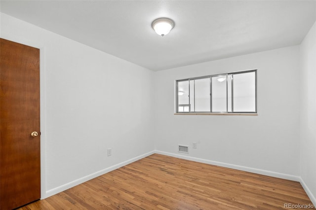 6627 Eaton St, Arvada, CO 80003 - empty room featuring wood finished floors and baseboards
