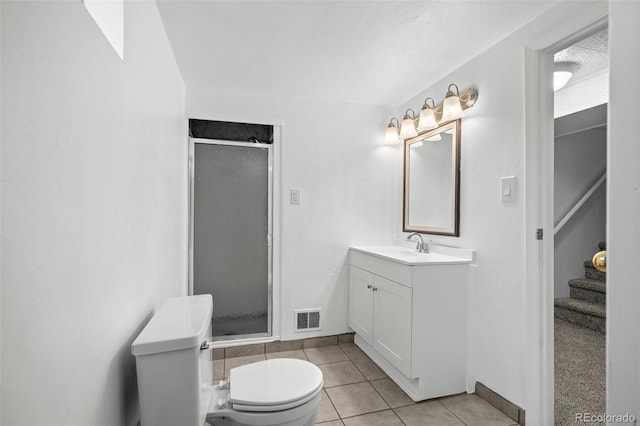 6627 Eaton St, Arvada, CO 80003 - full bathroom featuring toilet, a stall shower, vanity, tile patterned floors, and baseboards