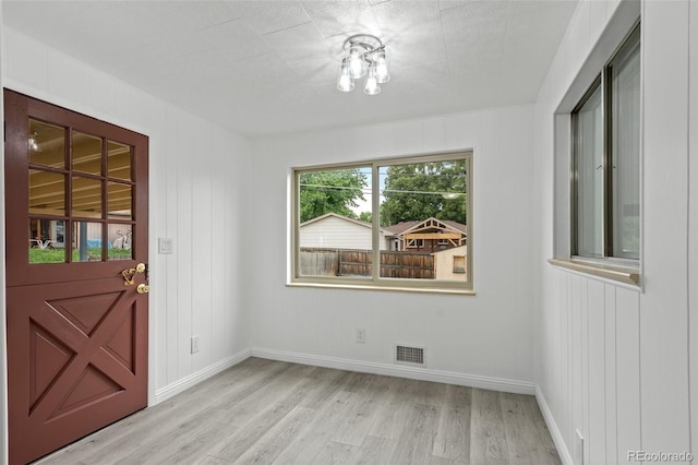 6627 Eaton St, Arvada, CO 80003 - foyer with light wood-style floors and baseboards