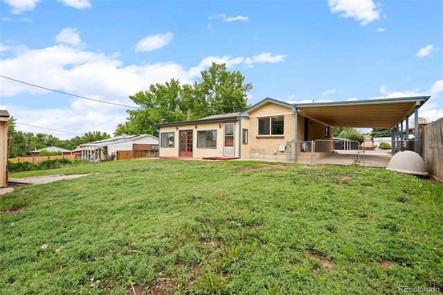 6627 Eaton St, Arvada, CO 80003 - back of property with an attached carport, a gate, and brick siding