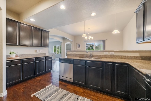 kitchen with pendant lighting, dishwasher, dark wood-type flooring, sink, and a chandelier