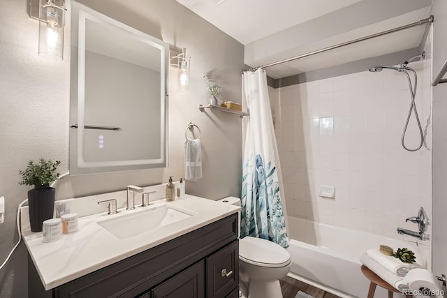 full bathroom with hardwood / wood-style flooring, toilet, vanity, and shower / bath combo