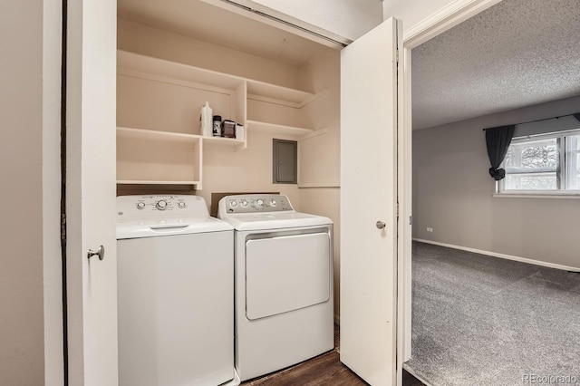 clothes washing area with dark colored carpet, a textured ceiling, and washer and dryer