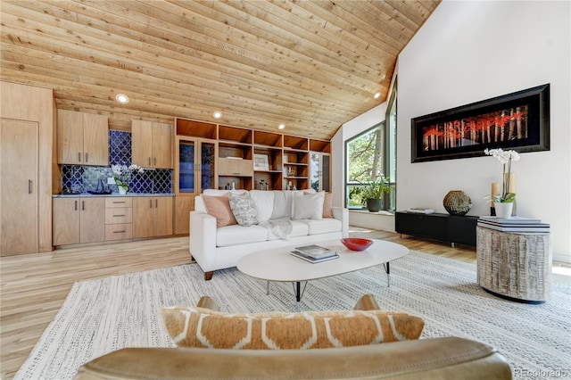 living area with light wood finished floors, wood ceiling, high vaulted ceiling, and recessed lighting