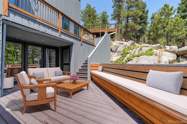 wooden deck featuring stairs and an outdoor living space