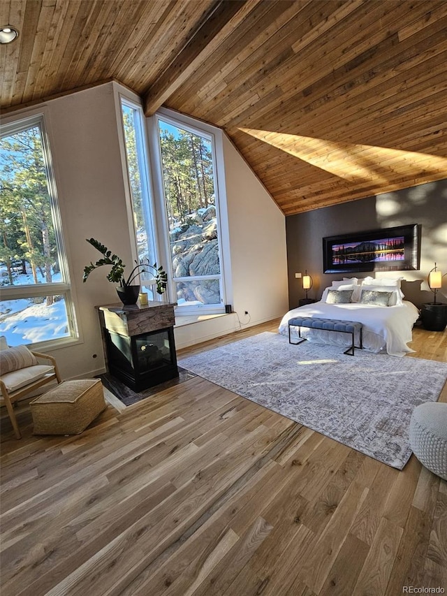 bedroom with lofted ceiling, wooden ceiling, and wood finished floors