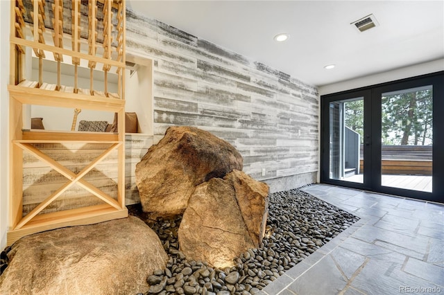 interior space featuring recessed lighting, stone tile floors, visible vents, and french doors