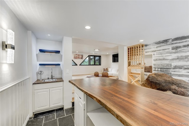 kitchen with white cabinets, butcher block countertops, open shelves, a sink, and recessed lighting