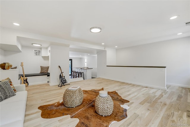 interior space with light wood-style floors, recessed lighting, visible vents, and baseboards