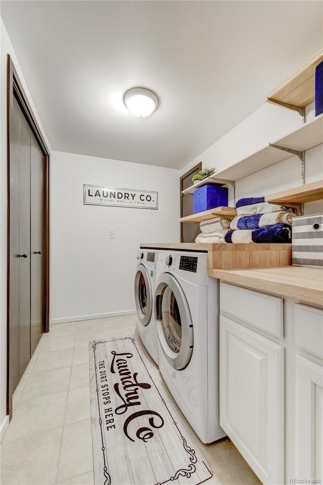 washroom with light tile patterned floors, laundry area, and separate washer and dryer