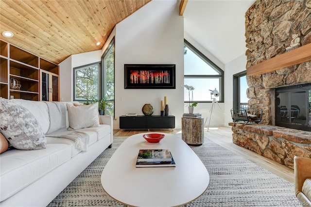 living room with high vaulted ceiling, wooden ceiling, a fireplace, wood finished floors, and plenty of natural light