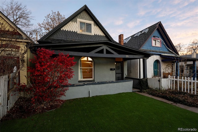 view of front of property featuring a yard and covered porch