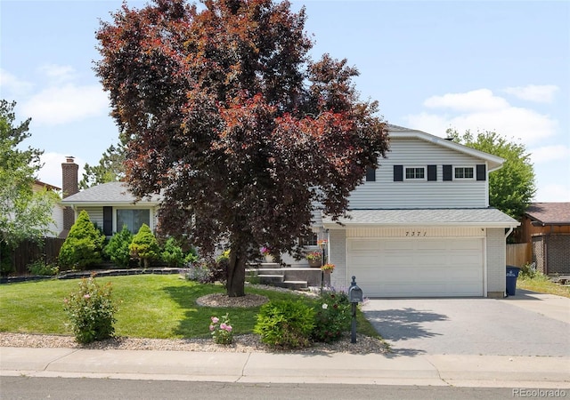 7371 Otis Ct, Arvada, CO 80003 - obstructed view of property with a garage, concrete driveway, and brick siding