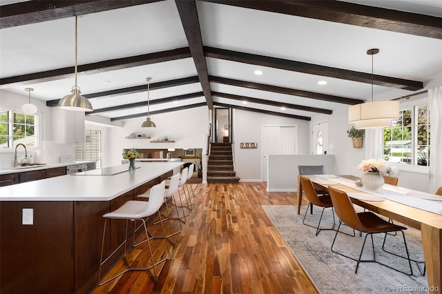 7371 Otis Ct, Arvada, CO 80003 - kitchen with light countertops, recessed lighting, baseboards, wood-type flooring, and a kitchen island