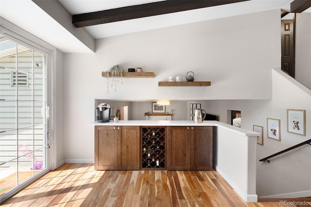 7371 Otis Ct, Arvada, CO 80003 - indoor wet bar with light wood finished floors, baseboards, and beam ceiling