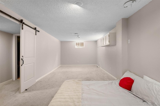 7371 Otis Ct, Arvada, CO 80003 - unfurnished bedroom featuring a textured ceiling, light colored carpet, a barn door, and baseboards